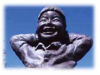 Bronze of a boy laughing with his hands behind his head
