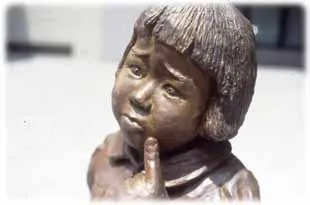 The bronze face of the girl sucking her finger
