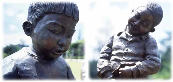 The bronze faces of the two boys