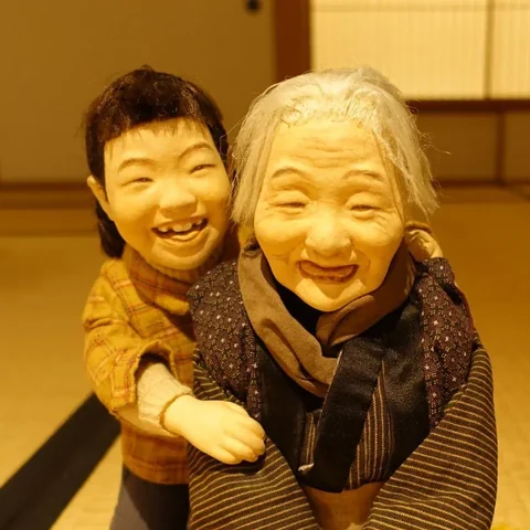 A laughing grandmother doll with her grandchild